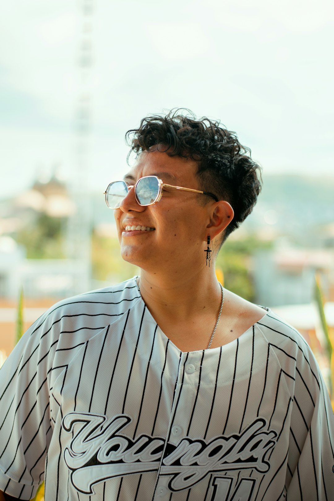 Studio portrait of a smiling Brazilian man with glasses