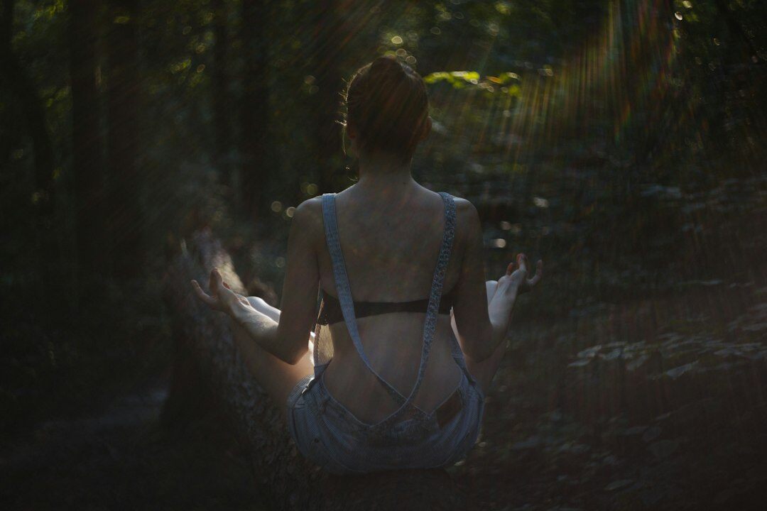 person meditating in nature